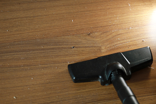 High angle view dusty vaccum cleaner on a wooden flooring