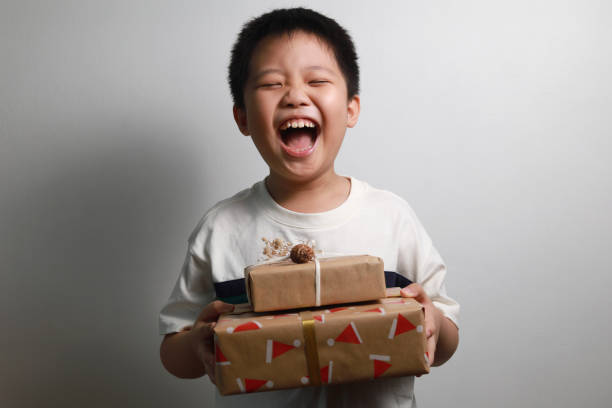Happy boy receiving Christmas gifts stock photo