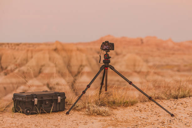 istock Camera on tripod next to camera case in front of vast canyon 1329613785