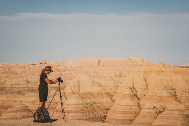 istock Man photographing rugged terrain in desert badlands 1329614666