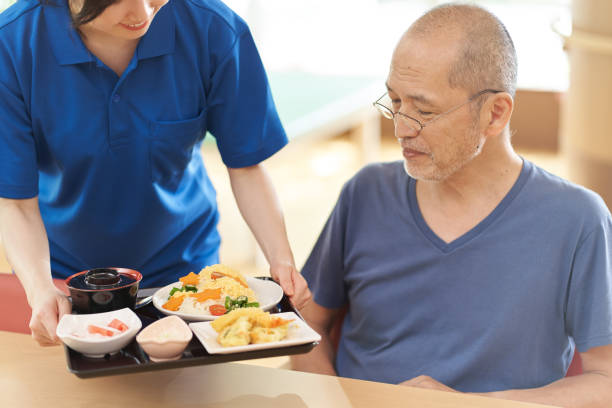 istock Caregiver serving the elderly 1329615310