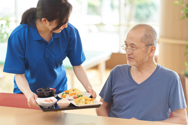 istock Caregiver serving the elderly 1329615312