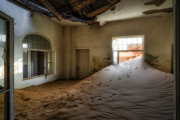 Abandoned Building in the Ghost Town of Kolmanskop Near Luderitz, Namib Desert, Namibia, Africa Abandoned building being taken over by encroaching sand in the old diamond mining town of Kolmanskop near Luderitz, Namib Desert, Namibia. abandoned place photos stock pictures, royalty-free photos & images