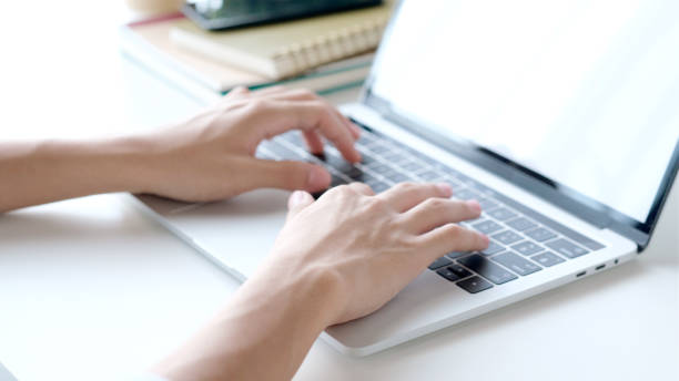 istock Close up of man hand typing laptop computer while working at home office, Student college online study, learning, people and technology 1329619689