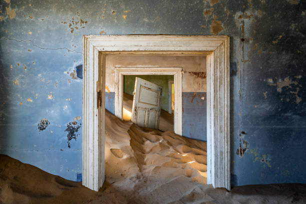 Abandoned Building in the Ghost Town of Kolmanskop Near Luderitz, Namib Desert, Namibia, Africa Abandoned building being taken over by encroaching sand in the Kolmanskop ghost town near Luderitz, Namib Desert, Namibia. abandoned place stock pictures, royalty-free photos & images