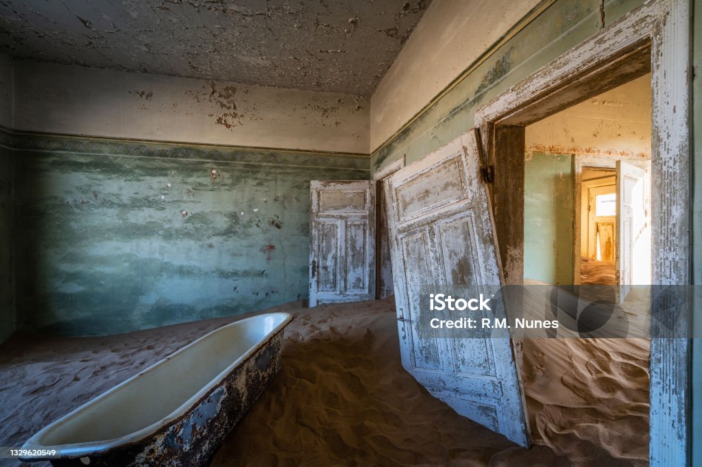 Abandoned Building in the Ghost Town of Kolmanskop Near Luderitz, Namib Desert, Namibia, Africa Abandoned building being taken over by encroaching sand in the Kolmanskop ghost town near Luderitz, Namib Desert, Namibia. Abandoned Stock Photo