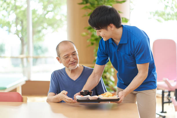 istock Caregiver serving the elderly 1329622730