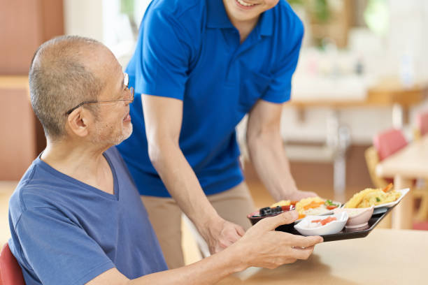 istock Caregiver serving the elderly 1329622732