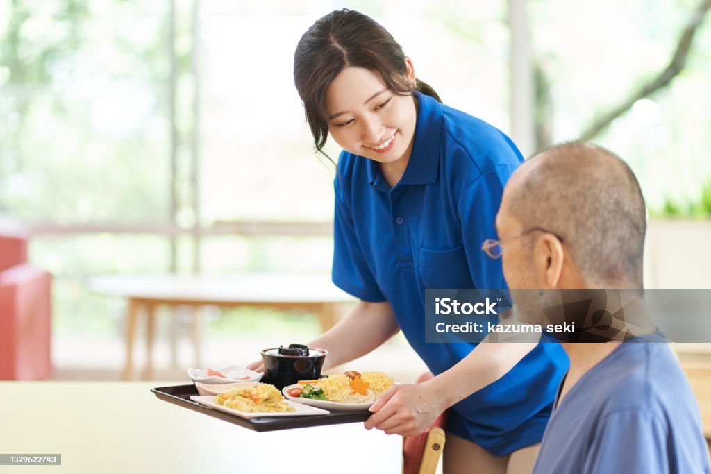 Caregiver serving the elderly Assisted Living Stock Photo