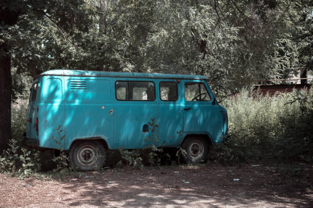 istock Retro transport recycling scrap metal, utilization, vintage old rusty car uaz abandoned destroyed on the street among the shits in the city on the street 1329626366