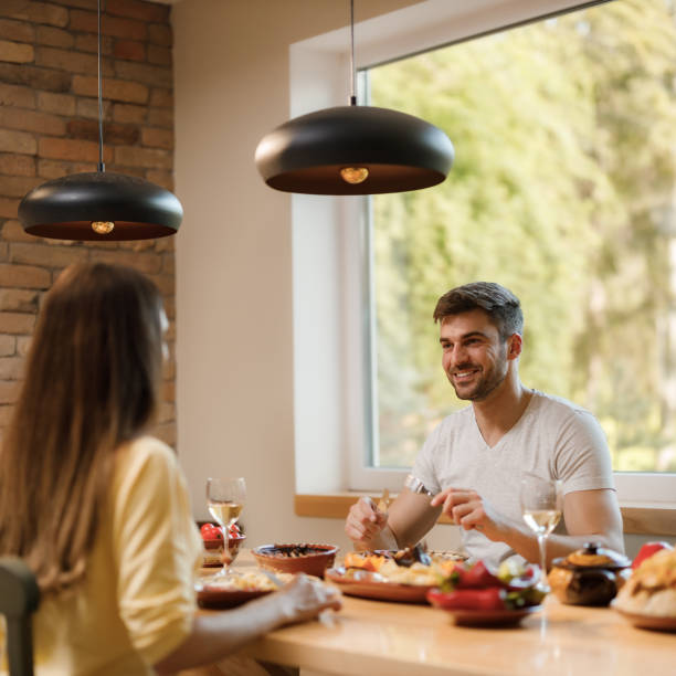 istock Happy couple talking during lunch at dining table. 1329628628
