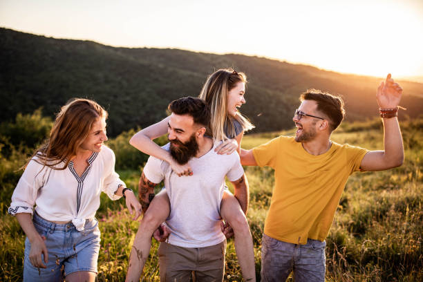 istock Happy friends having fun while walking in nature at sunset. 1329630291