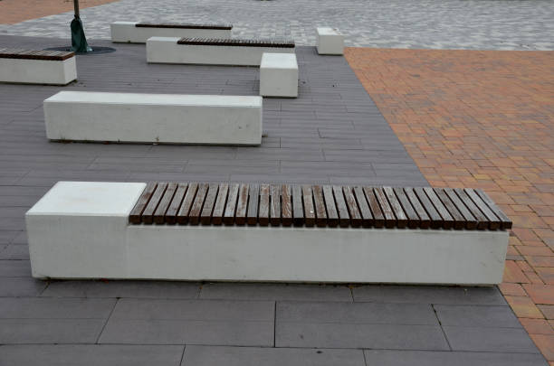 istock concrete white bench block and wave shape in the park on a dark cobbled square, clean concrete surface gray brown white pedestrian and rest area at the skate park for young people, teenagers 1329630543