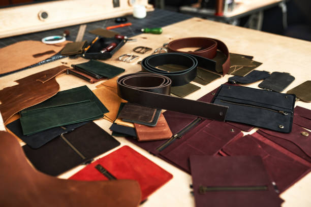 istock Leather craftsman's work table with products, showing the workflow and clutter at the workplace at the time of leather products production 1329632826