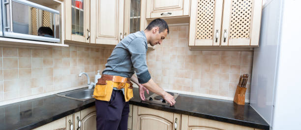istock the worker installs an electric stove 1329633080