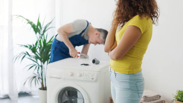 istock Professional plumber repairing a broken washing machine 1329634539