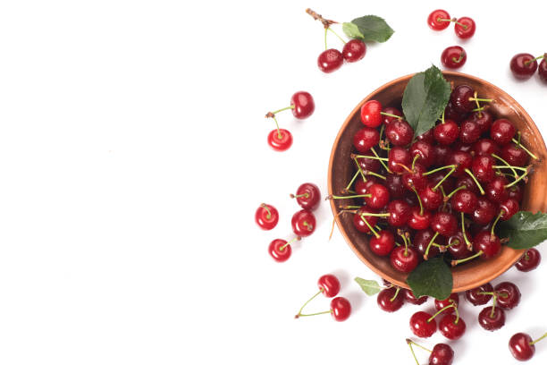 istock Bowl of fresh red cherries on white background 1329635957