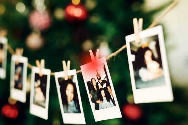 prise d’un fort de photographies de famille accrochées à un arbre pendant noël à la maison - making memories photos et images de collection