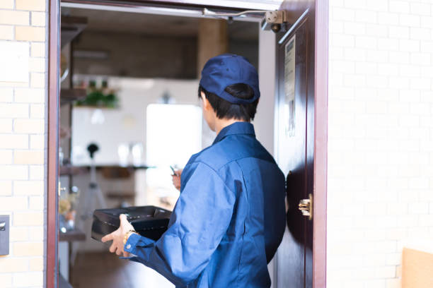 istock A male delivery man delivering a box 1329637096