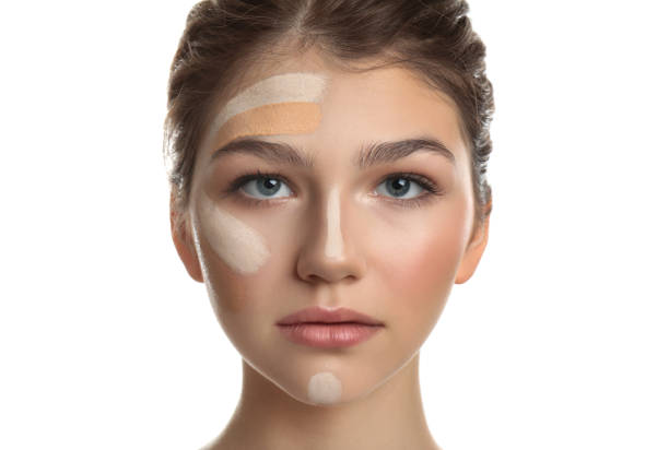 istock Beautiful girl on white background. Using concealer and foundation for face contouring 1329639821