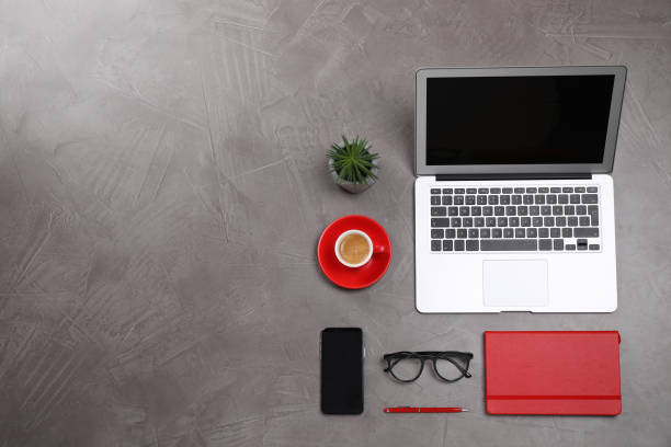 istock Flat lay composition with modern laptop and cup of coffee on grey table, space for text 1329640003