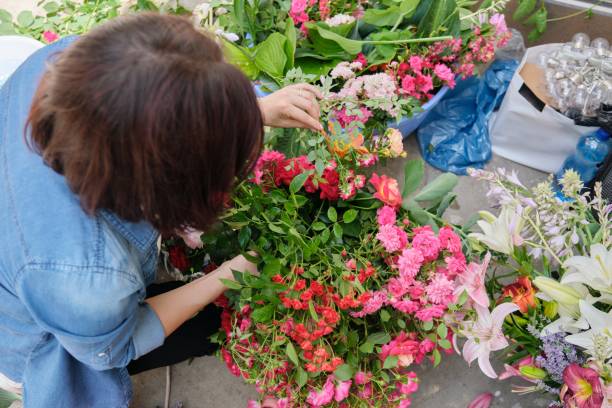 istock Female florist working with flowers outdoors, decorating events with flowers 1329640139