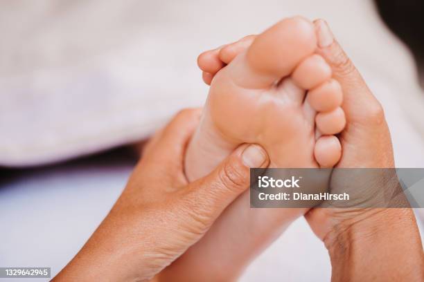 Close Up Of Foot Reflexology Showing Female Hands On A Acupressure Point On The Plantar Surface Stock Photo - Download Image Now