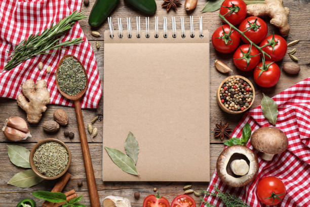 istock Open recipe book and different ingredients on wooden table, flat lay. Space for text 1329646427