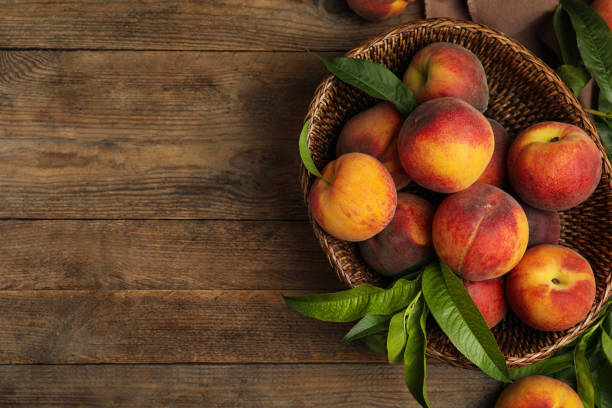 istock Fresh ripe juicy peaches on wooden table, flat lay. Space for text 1329646678