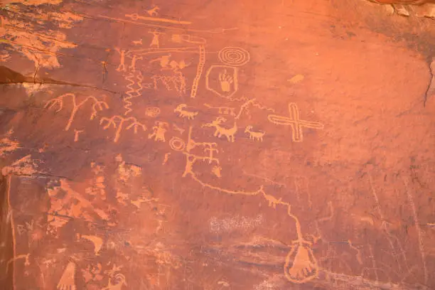 Photo of Graffiti of Stone Age petroglyphs  Prehistoric embroidery by Bushman on Twyfelfontein. Panel with rock paintings of animals and symbols in Namibia