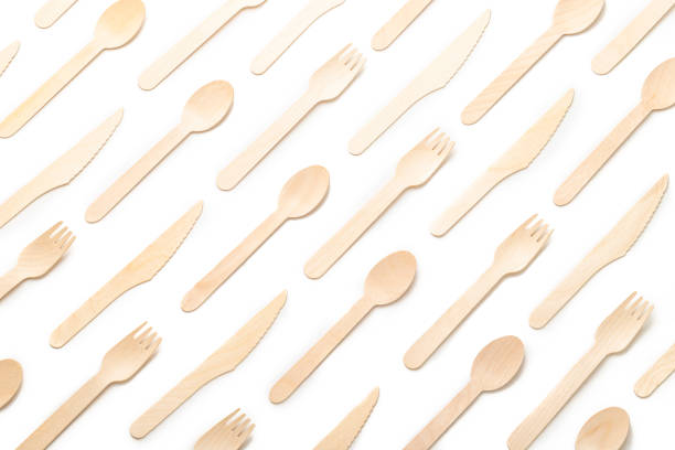 recycled disposable cutlery pattern Top view of a background pattern made of eco friendly disposable cutlery on white background fork photos stock pictures, royalty-free photos & images