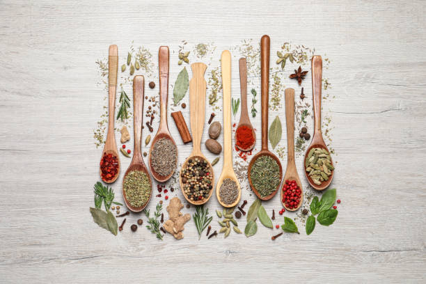 istock Different natural spices and herbs on light wooden table, flat lay 1329650234