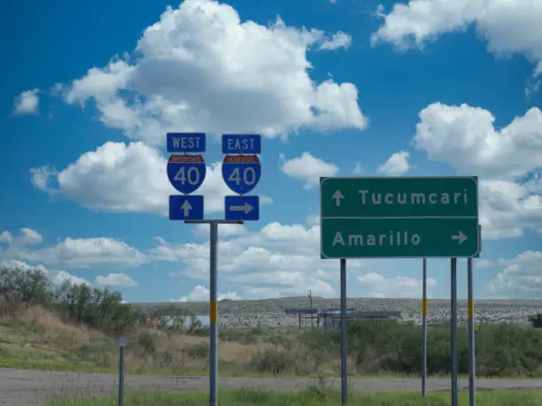 Roadside sign with directions and distances to Tucumcari and Amarillo along Interstate 40, New Mexico.