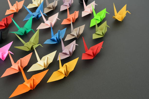 istock Origami paper cranes on black background. 1329651344