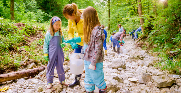 istock Volunteers picking up trash in forest 1329652400
