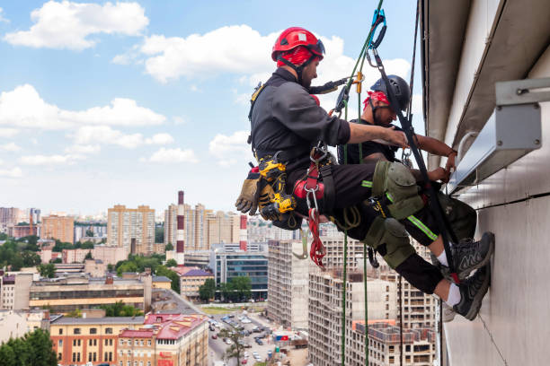 istock Industrial mountaineering worker hangs over residential building 1329652508