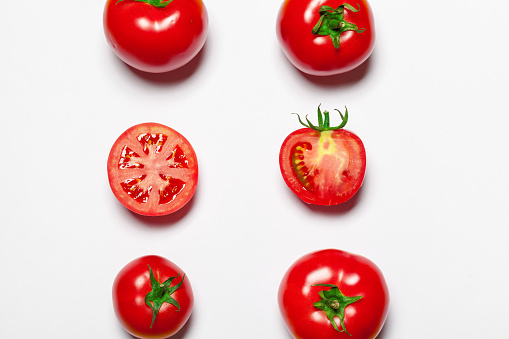 Top view of bunch of fresh tomatoes isolated on white background