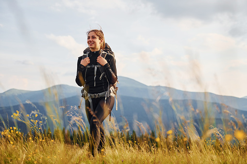 Girl in black sportive clothes. Majestic Carpathian Mountains. Beautiful landscape of untouched nature.