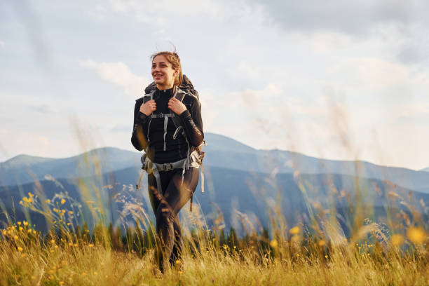 Girl in black sportive clothes. Majestic Carpathian Mountains. Beautiful landscape of untouched nature stock photo