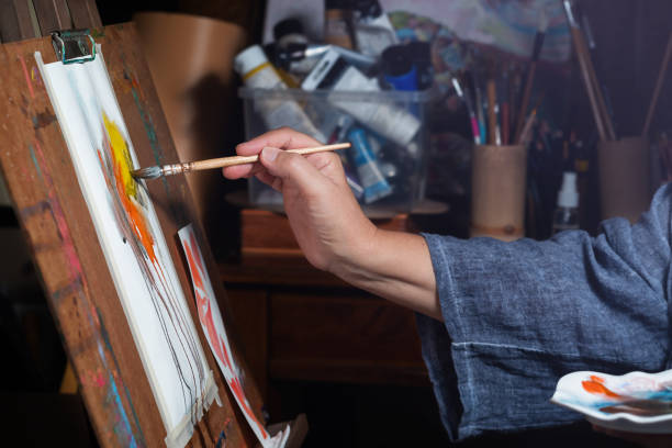 istock Woman artist paints 1329658718