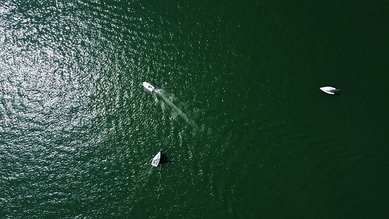 Aerial drone view of sailing boat on a river.