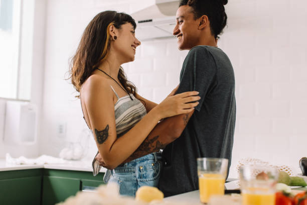 istock Sweet couple being romantic in the kitchen 1329660816