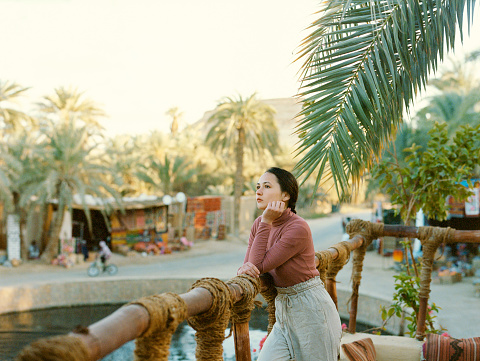Portrait of young Caucasian  woman in oasis in Egypt. Medium format film