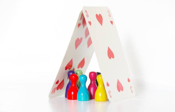 Game figures seek protection under two playing cards heart