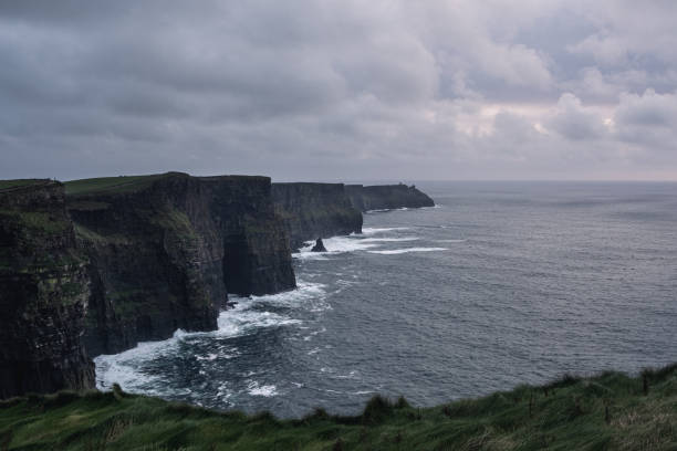istock Dark clouds over amazing Cliffs of Moher 1329663214