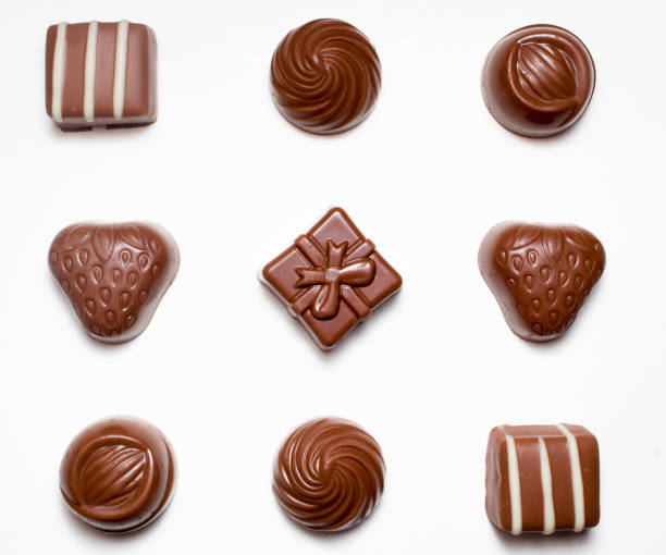 istock Top view of chocolates isolated on white background. 1329663400