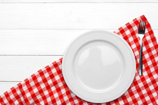 istock Empty plate and towel over wooden table background. 1329664058