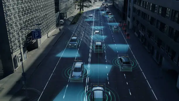 Photo of Aerial Drone Shot: Autonomous Self Driving Cars Moving Through City. Concept: Artificial Intelligence Scans Surrounding Environment, Detecting Cars, Pedestrians, Avoids Traffic Jams and Drives Safely.