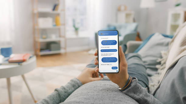 istock Man at Home Lying on a Couch using Smartphone with Green Mock-up Screen, Doing Swiping, Scrolling Gestures. Guy Using Mobile Phone, Internet Social Networks Browsing. Point of View Shot. 1329665114