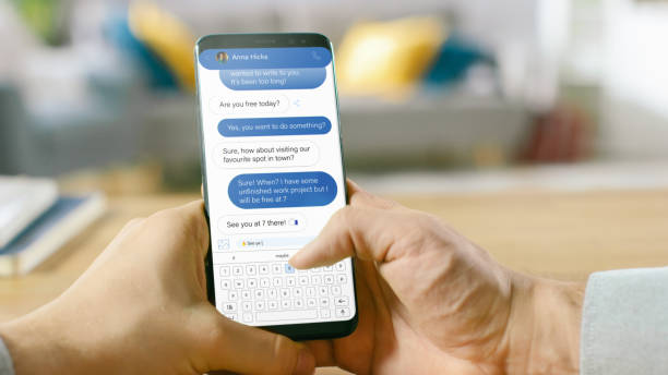 istock Close-up of a Man Uses Green Mock-up Screen Smartphone and Does Touchscreen Gestures. Touching Mobile Phone Chroma Key Screen. In the Background Cozy Homely Atmosphere. 1329665131